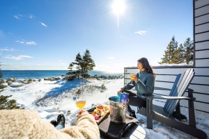 Couple sipping wine of the Treehouse balcony